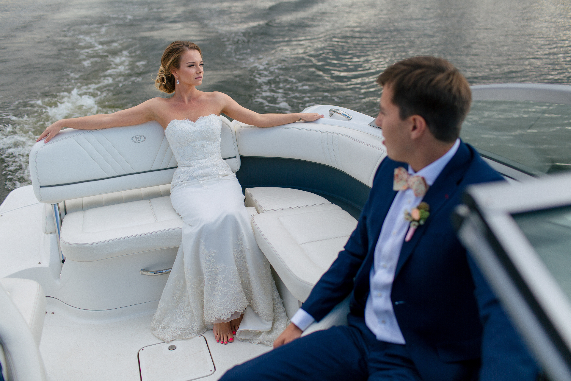 Wedding couple on boat with waterfront view